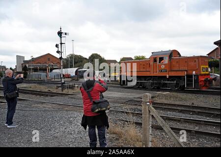 Rail enthusiasts photographing a British Rail class 37 diesel locomotive as it arrives at Kidderminster station, Severn Valley Railway Stock Photo