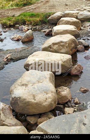 Large stepping stones across a burn on the path to the Fairy Pools on the Isle of Skye, Scotland, United Kingdom, Europe. Stock Photo