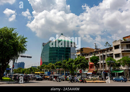 A new office building is under construction and towers over a busy city street in urban Phnom Penh, Cambodia. Stock Photo