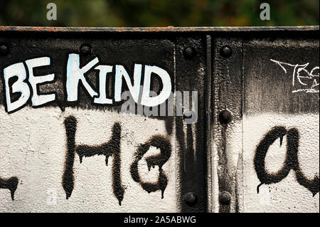 Graffiti on iron bridge in monochrome saying Be Kind Stock Photo