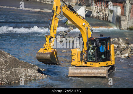 An excavator working on the riverbed. Stock Photo