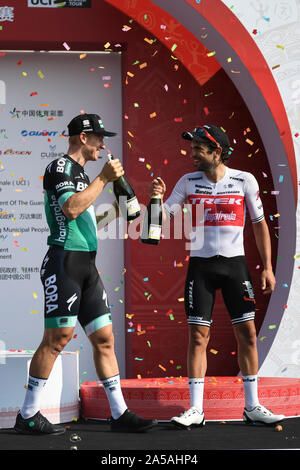 (191019) -- NANNING, Oct. 19, 2019 (Xinhua) -- German Pascal Ackermann (L) of Bora-Hansgrohe celebrates with Italian Jacopo Mosca of Trek-Segafredo during the awarding ceremony of the stage three circuit race at the 2019 UCI World Tour/Tour of Guangxi in Nanning, capital of south China's Guangxi Zhuang Autonomous Region, Oct. 19, 2019. (Xinhua/Cao Yiming) Stock Photo