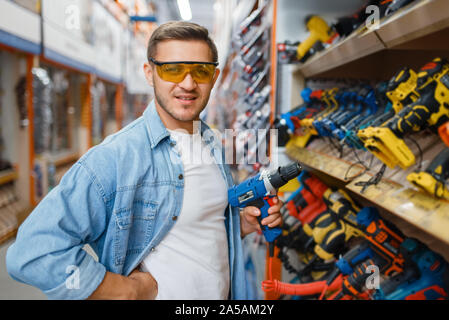 Buyer holding electric screwdriver, hardware store Stock Photo