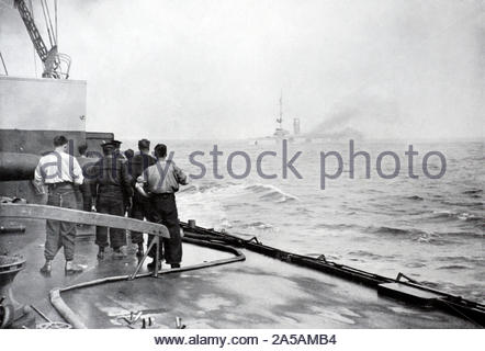 WW1 British Sailors watching the sinking of the German cruiser SMS Mainz at the Battle of Heligoland Bight in the North Sea  28th August 1914, vintage photograph from 1914 Stock Photo