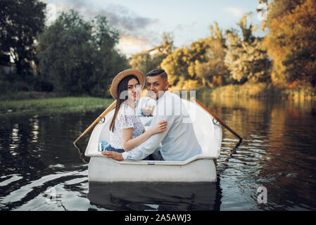 Happy love couple boating on lake, romantic date Stock Photo