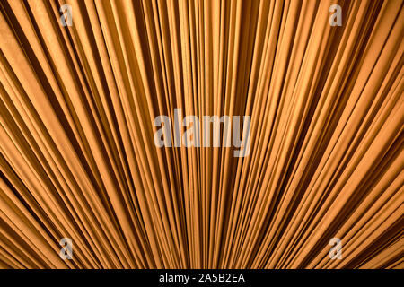Gold colored fabric stretched diagonally as a background. Stock Photo