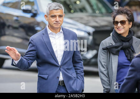 London, UK, 19 Oct 2019. Mayor Sadiq Khan and his wife walk at front of the march and happily poses with groups of protesters. Hundreds of thousands of protesters in colourful outfits, with flags and banners, and from all over the UK, march for the right to a 'People's Vote' on any Brexit deal reached.  The march makes its way on a route from Park Lane, Hyde Park, through central London, and ends in Parliament Square where Parliament today sits to vote on the deal. Credit: Imageplotter/Alamy Live News Stock Photo