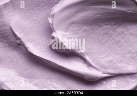Gently purple texture and strokes of a facial cleansing mask or acrylic paint isolated on a white background Stock Photo