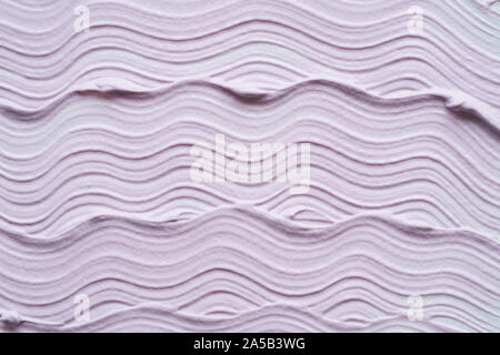 Gently purple texture and strokes of a facial cleansing mask or acrylic paint isolated on a white background Stock Photo