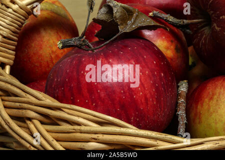 Arrangement of ripe red apples lying in a basket Stock Photo