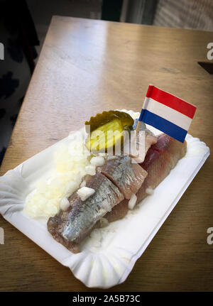 Haring ‘Hollandse Nieuwe’ (Dutch new herring), a famous Dutch food speciality. The raw herring is typically served as street food Stock Photo