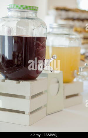 Glass jars of lemonade on wedding candy bar. Catering. Drinks on wedding party. Stock Photo