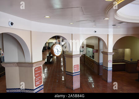 SANTA ANA, CALIFORNIA - 14 OCT 2019: Interior of the Santa Ana Train Station with Clock and Ticket Counters. Stock Photo