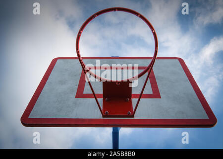 Basketball hoop against blue sky bottom view. Stock Photo