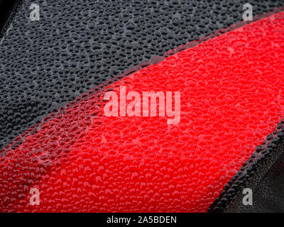Wet beautiful car Headlamp, black car with water drop. Close up Side view shot from side of vehicle. Detailing concept. Stock Photo