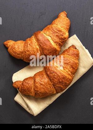 Croissants on grey slate background. Vertical image, top view. Stock Photo