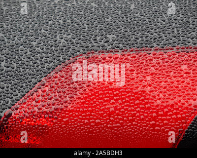 Wet beautiful car Headlamp, black car with water drop. Close up Side view shot from side of vehicle. Detailing concept. Stock Photo