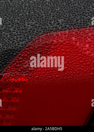 Wet beautiful car Headlamp, black car with water drop. Close up Side view shot from side of vehicle. Detailing concept. Stock Photo