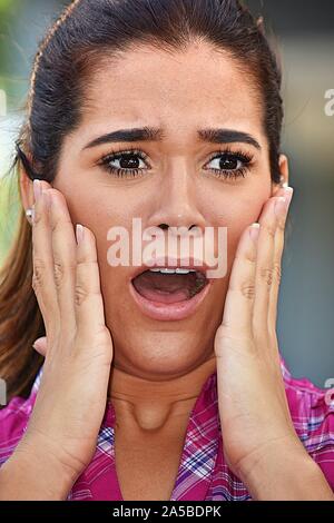 Startled Young Woman Wearing Pink Shirt Stock Photo