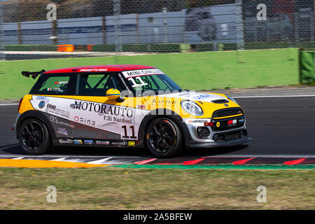 Vallelunga, Italy september 15 2019. Full length of racing Mini Cooper car in action at turn during race in circuit, blurred motion background Stock Photo