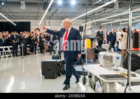 U.S President Donald Trump, center, joins a ribbon cutting ceremony at the  newly opened Louis Vuitton Workshop Rochambeau October 17, 2019 in Alvarado,  Texas. Joining the president from left to right are