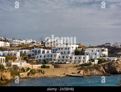 Landmark white buildings lined up on sea shore  in the town of mykonos greece Stock Photo