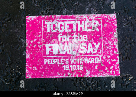 19 Oct 2019. UK. People's Vote march in central London to coincide with the Saturday sitting of Parliament to vote on Boris Johnson's Brexit deal.  A Together For The Final Say banner abandoned in the rain on a wet roadway.  Credit: UrbanImages-News/Alamy. Stock Photo