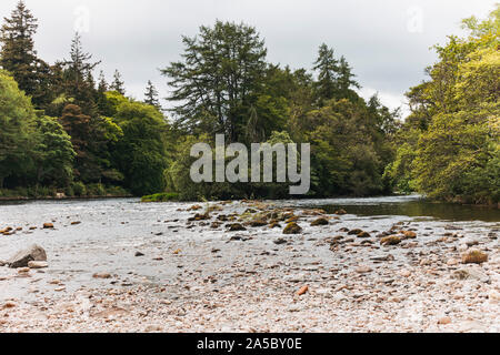 Upstream on the River Ness, looking toward Ness Islands, on a brisk spring day in Inverness, Scotland Stock Photo