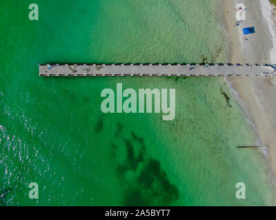 Aerial top view of Cortez beach withe sand beach and his little wood pier on blue water, Anna Maria Island, Florida, USA Stock Photo