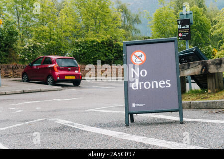 A sign in a carpark indicating 'No drones' - near a tourist attraction in Loch Ness, United Kingdom Stock Photo