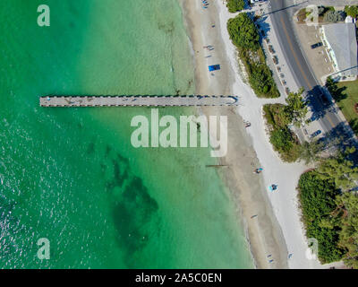 Aerial top view of Cortez beach withe sand beach and his little wood pier on blue water, Anna Maria Island, Florida, USA Stock Photo