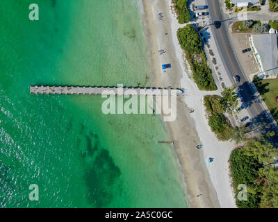 Aerial top view of Cortez beach withe sand beach and his little wood pier on blue water, Anna Maria Island, Florida, USA Stock Photo