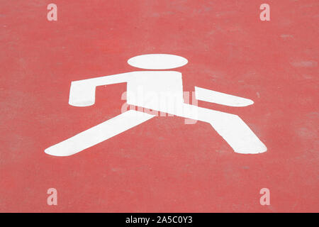 Walk way sign painted on the floor. Human icon walking on red background Stock Photo