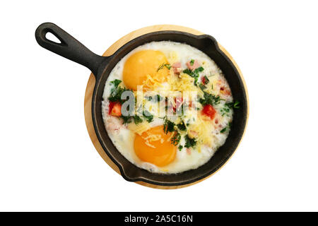 Fried eggs with vegetables in frying pan isolated on white background. Top view. Stock Photo
