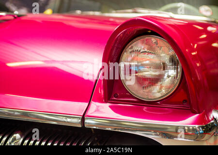 Headlight lamp vintage car. Classic car headlight. Close-up of headlights of orange vintage car. Exhibition. Stock Photo