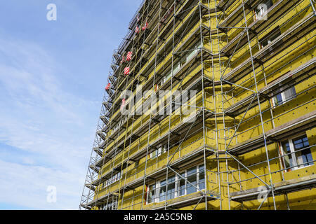 scaffolding arround the house to install thermal insulation of the apartment building facade Stock Photo