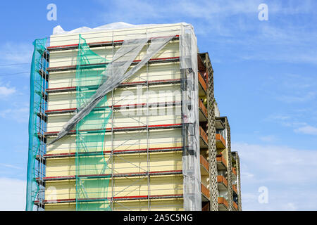 scaffolding arround the house to install thermal insulation of the apartment building facade Stock Photo