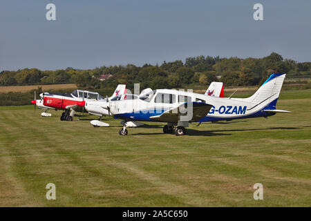 Light aircraft parked on grass. Wolverhampton Halfpenny Green Airport. South Staffordshire. UK Stock Photo