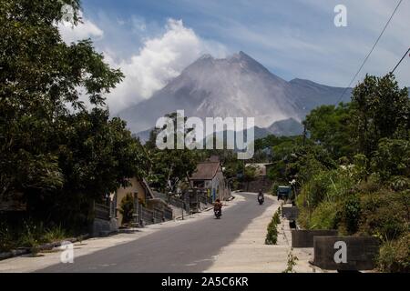 View of Mount Merapi with smoke from Glagaharjo Village.Based on information from the Institute for Investigation and Development of Geological Disaster Technology (BPPTKG), the level of activity of Merapi is still on alert or Level 2, Residents are advised to remain calm and not be active within a radius of less than 3 kilometers from the mountain peak. Stock Photo