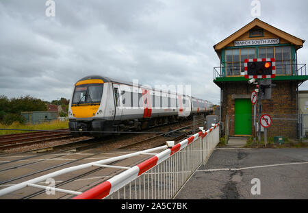 Greater Anglia Class 170 DMU passes the level crossing at March South Junction on the Ely-Peterborough Line, Cambridgeshire, UK Stock Photo