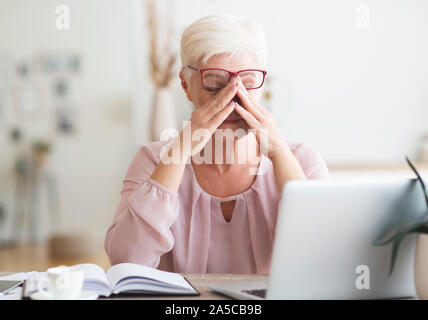 Old exhausted business woman feeling very tired Stock Photo