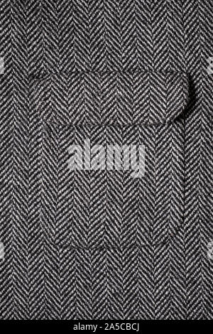The texture of the fabric for the coat. Closeup of wool herringbone fabric. weed, Wool Background Texture. Stock Photo
