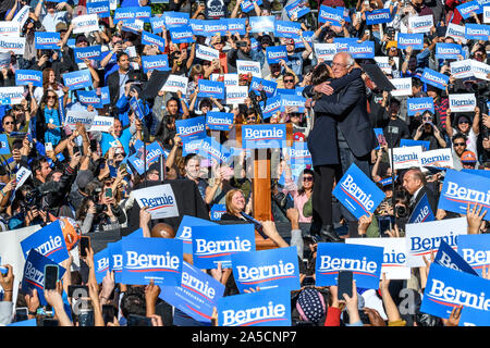 New York, USA,  19 October 2019.  Representative Alexandria Ocasio-Cortez embraces Senator Bernie Sanders  in Queens, New York. Ocasio-Cortez endorsed 2020 democratic presidential candidate Sanders in his first rally after suffering a heart attack.  Credit: Enrique Shore/Alamy Live News Stock Photo