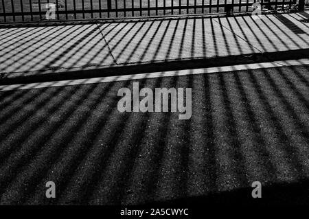 Greyscale shot of a ground with reflections of lines creating a symmetric pattern Stock Photo