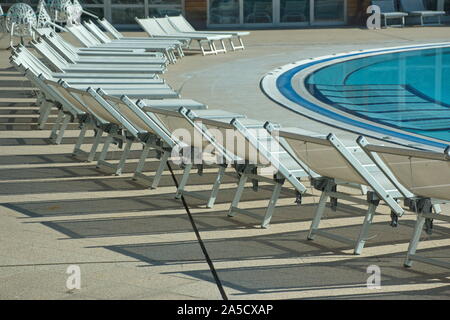 Outdoor swimming pool with chairs in hotel resort Stock Photo