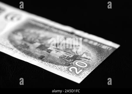 Twenty Hong Kong dollars banknote on a dark background close-up, black and white Stock Photo