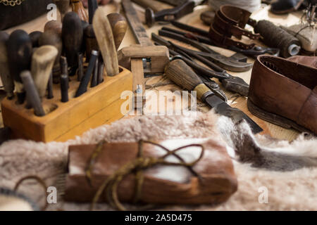 Set of leather working tools on working desk Stock Photo