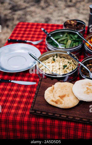 African Tanzanian cuisine with baked Chapati nan flatbread - African lunch meal for safari trip picnic Stock Photo