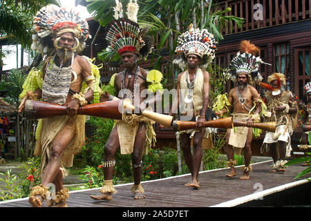 Row of Traditionally Dressed Men with Kundu Drums Stock Photo