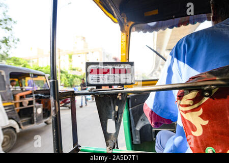 A unidentified driver is riding an auto rickshaw through the busy streets of Jaipur. Stock Photo